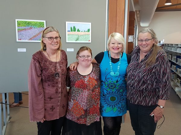 Sarah Bowkett (second from left) at her art exhibition last year.