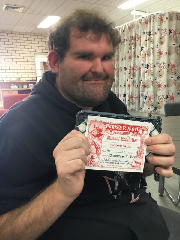 Shannon Miller displaying his second place certificate from the 2017 Parkes Show